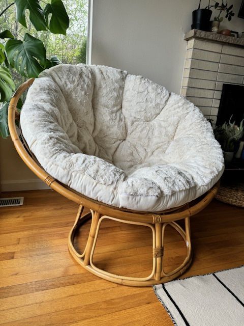 Pier 1 Papasan chair with the wooden frame and cream velvet cushion
