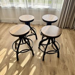 Distressed Black Metal Adjustable Height Backless Swivel Stool (set of 4)