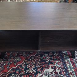 Dark Brown Coffee Table.  Pop-up Lid With Storage. Front Of Coffee Table Has Two Cubbies 