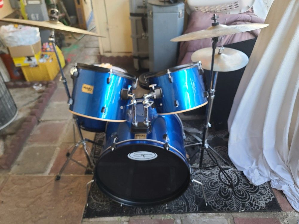 Complete 5 Pc Mendini Drum Set in a Metallic Blue Plastic Wrap Complete with Bass Pedal, Cymbals, Hardware and Seat = $175