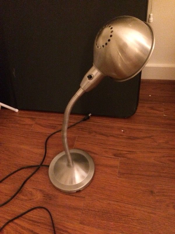 Beautiful metal lamp with working bulb for nightstand or desk