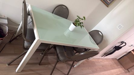 Glass table with four chairs