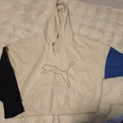 This is a Puma Women's Modern Sport Hoodie in a color-blocked design featuring off-white, black, and blue panels. 