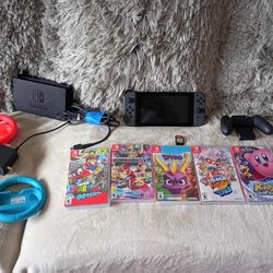 Nintendo Switch console with Joy-Con controllers, games, and accessories