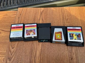 Atari 2600 game cartridges , including titles like Star Voyager, Dragonfire, Dark Cavern, Reactor, and Riddle of the Sphinx