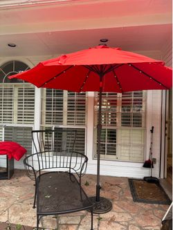 Wrought iron lounge chair and umbrella & stand