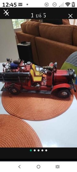 This is a handcrafted vintage-style metal fire truck collectible model.