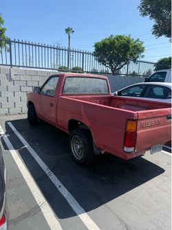 Red 1988 Nissan Frontier King Cab.