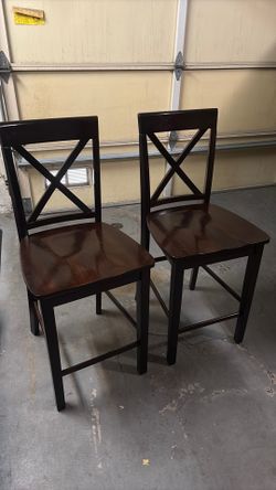 2 brown bar stools/chairs