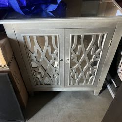 MIRRORED GLASS ACCENT CABINET WITH DECORATIVE DOORS