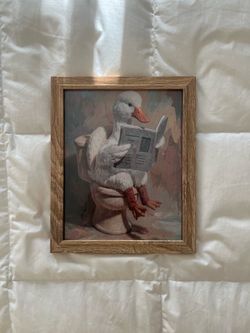 Framed duck on toilet reading