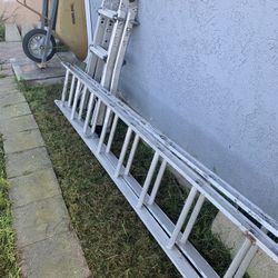 Two ladders, one wheelbarrow and a 6 foot metal plank