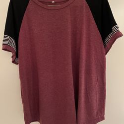 raglan t-shirt with a maroon body, black sleeves, and striped cuffs