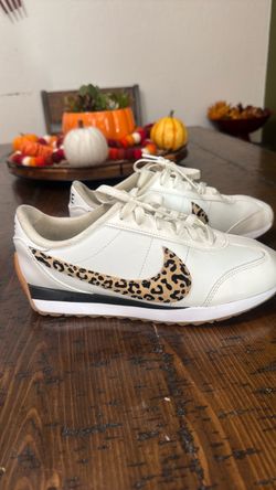 Women’s white Nike with cheetah swoosho