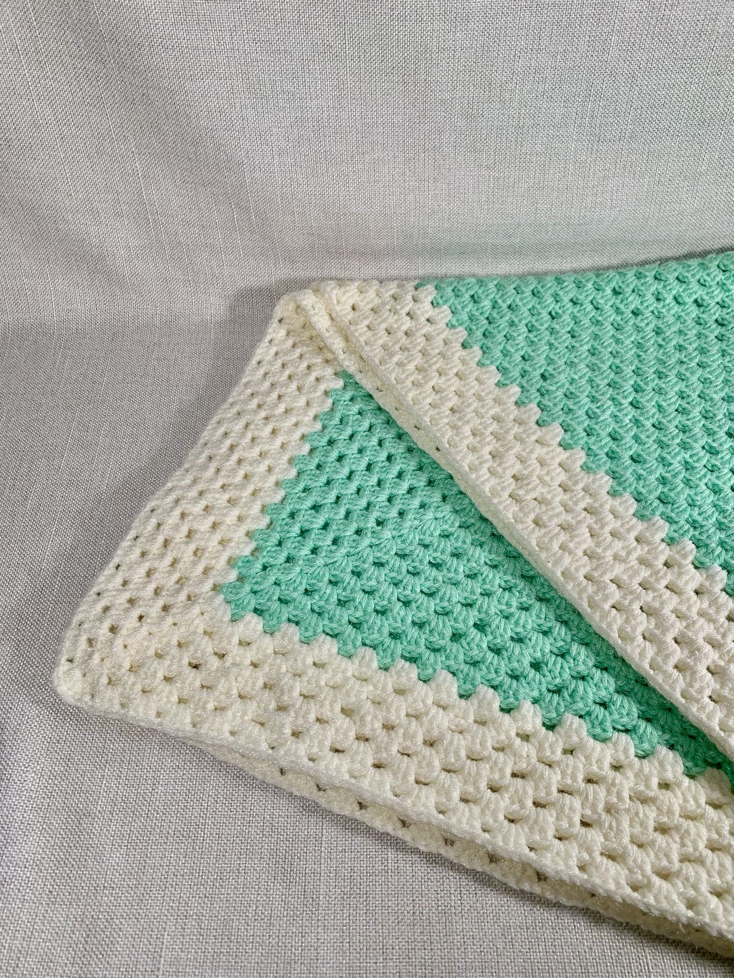 Bright And Colorful Handmade Crochet Baby Blanket With Mint Green Center And White Border.