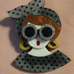 Cute brooch of a girl with sunglasses.