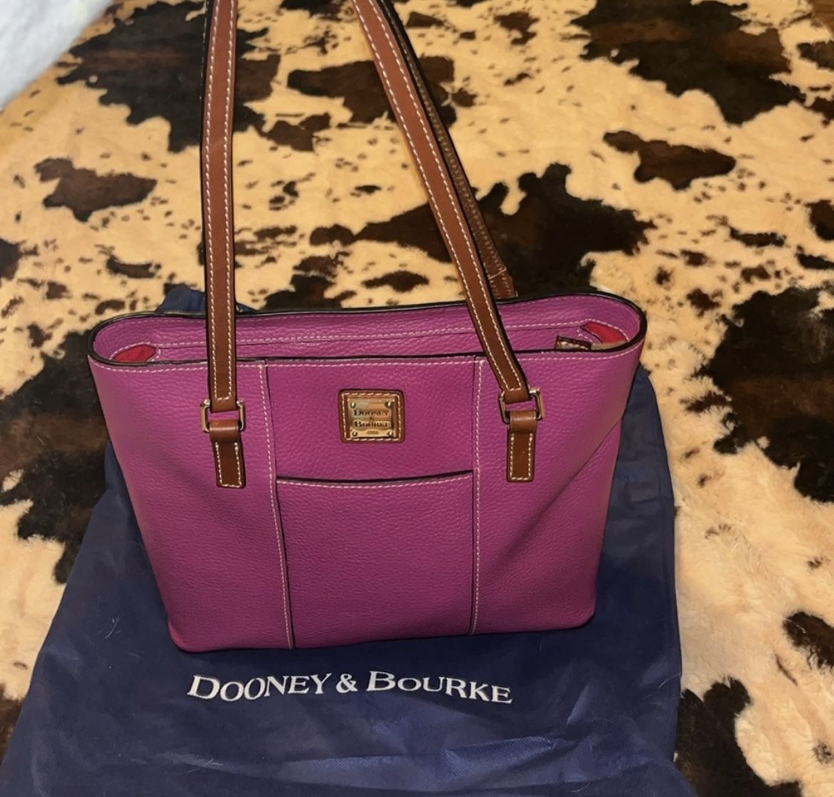 Light plum Dooney & Bourke handbag pebble grain with brown details; zipper close