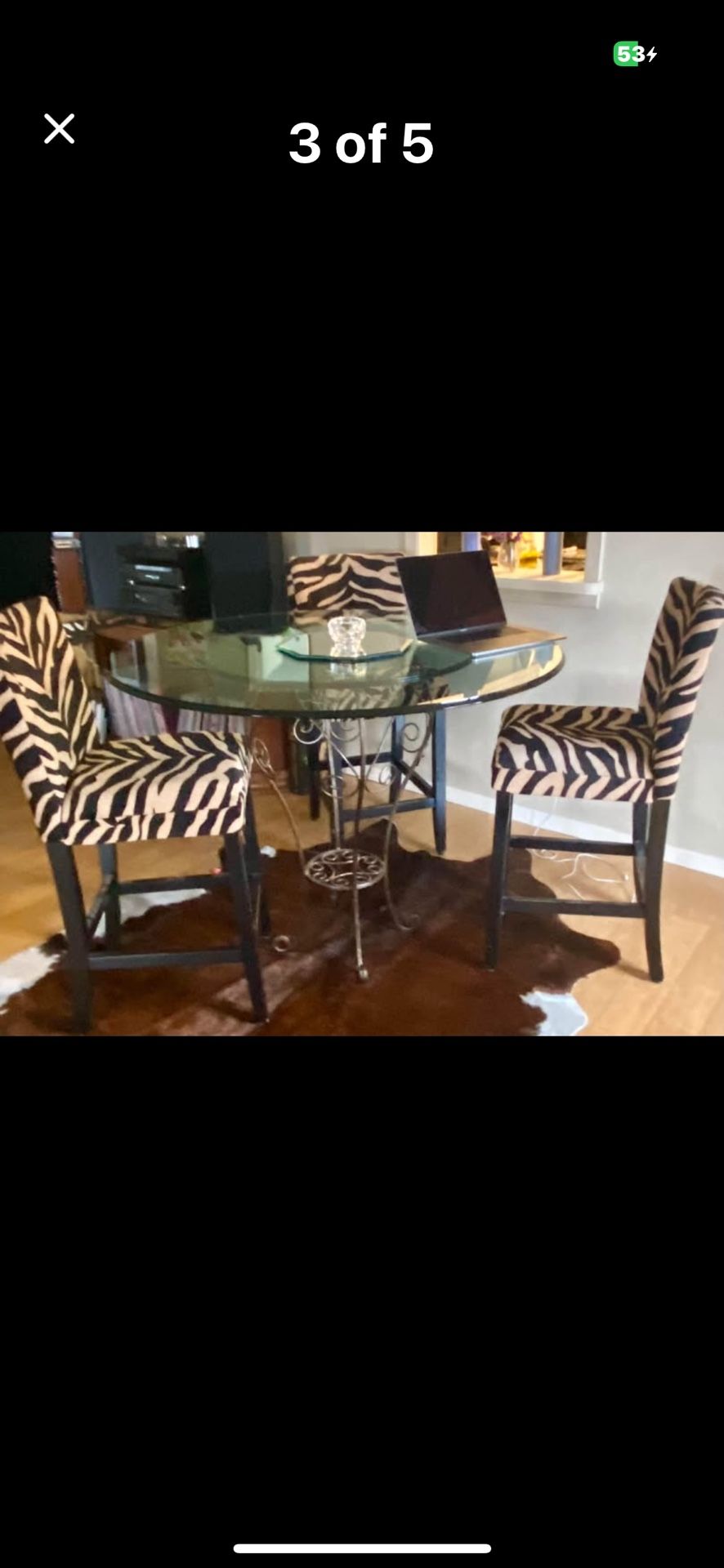 Glass top bar height table with three stools