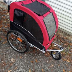 2 BRAND NEW BIKE TRAILERS/STROLLERS FOR PETS/KIDS RED IS LG/GREEN IS SMALL $200 FOR BOTH PRICE IS FIRM