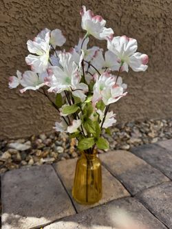 Small amber glass vase with white flowers