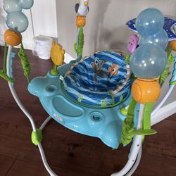 Bright Starts Disney Baby Finding Nemo Sea of Activities Baby Activity Center Jumper with Interactive Toys, Lights, Songs & Sounds, 6-12 Months (Blue