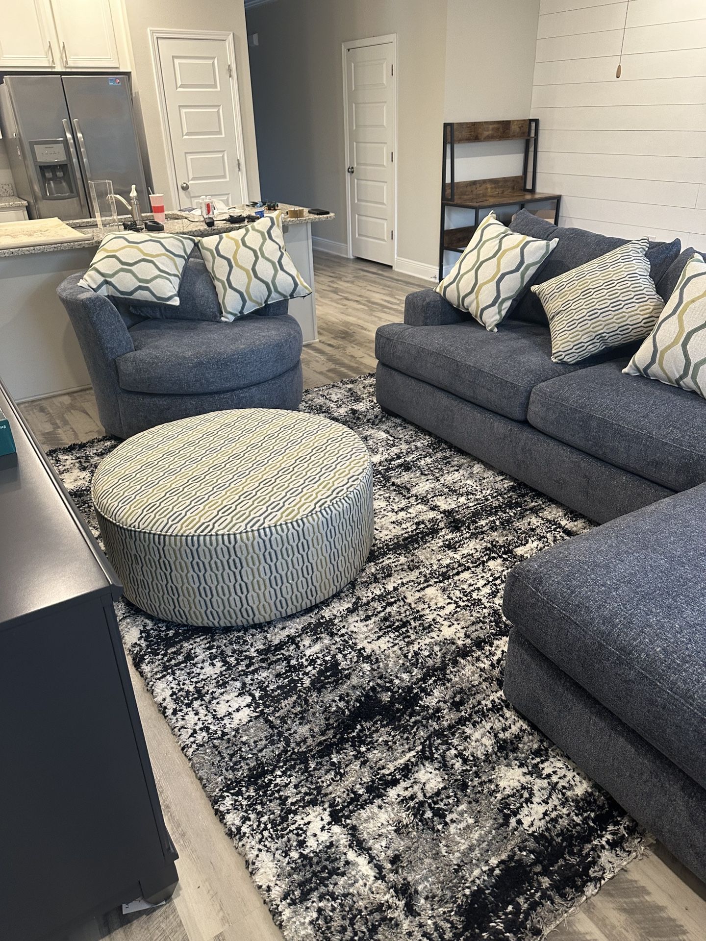 Comfy Circular Blue Sofa Chair And Patterned Ottoman Brighten Up Any Common Area