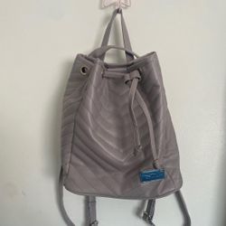 Beautiful grey and silver leather backpack with a unique design