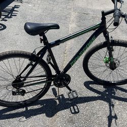 Mongoose Excursion mountain bike, 26 inch wheel, 21 speeds, mens frame, black / green