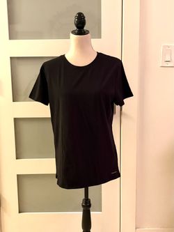 Calvin Klein's black t-shirt has a classic fit and features a small, subtle logo on the bottom hem.