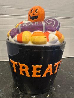 Vintage Halloween treat  jar, candy design on top. 10 inches tall.
