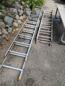 Two aluminum extension ladders
