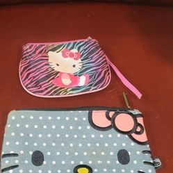 Hello Kitty pouches: 
Top Pouch: This is a Hello Kitty pink zebra print coin purse or wristlet, possibly from the brand Fab Starpoint.
Bottom Pouch: T