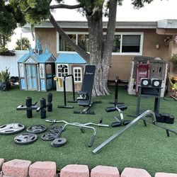 Iron Master Bench, Dumbbells, Attachments, Weights, And Curl Bar. 