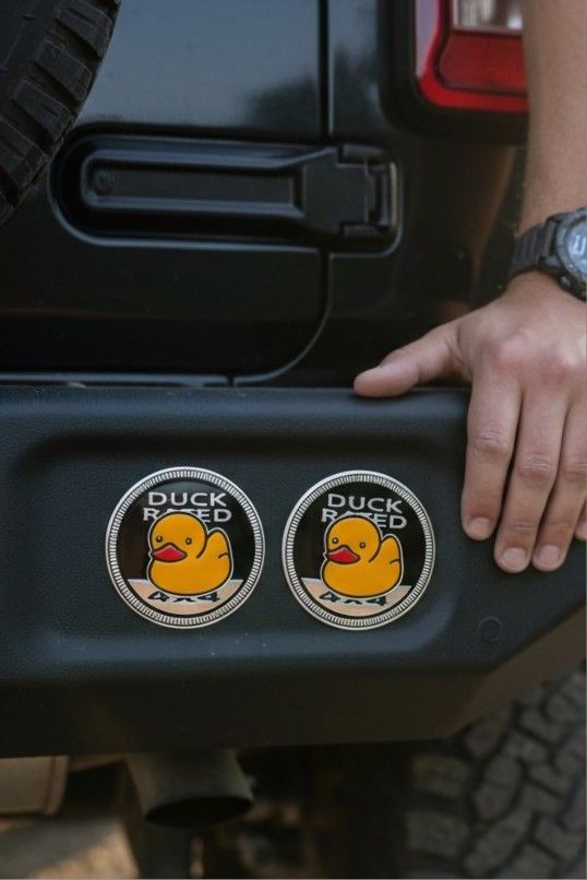 2-Piece Duck Rated Badge 2.36" Auto Fender Emblem Adhesive Sticker 4x4 SUV Truck. This is a "Duck Rated 4x4" metal automotive badge or emblem. It is s