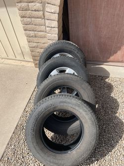 Four 265/70/17 Tires And Two 17” RAM Wheels