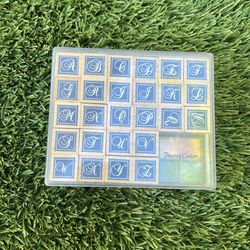 26 individual wooden stamps, one for each letter of the alphabet.