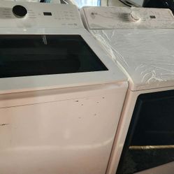 LG 5.5 Cu. Ft. Top Load Washer and 7.3 Cu. Ft. Electric Dryer with AI Sensing in White.