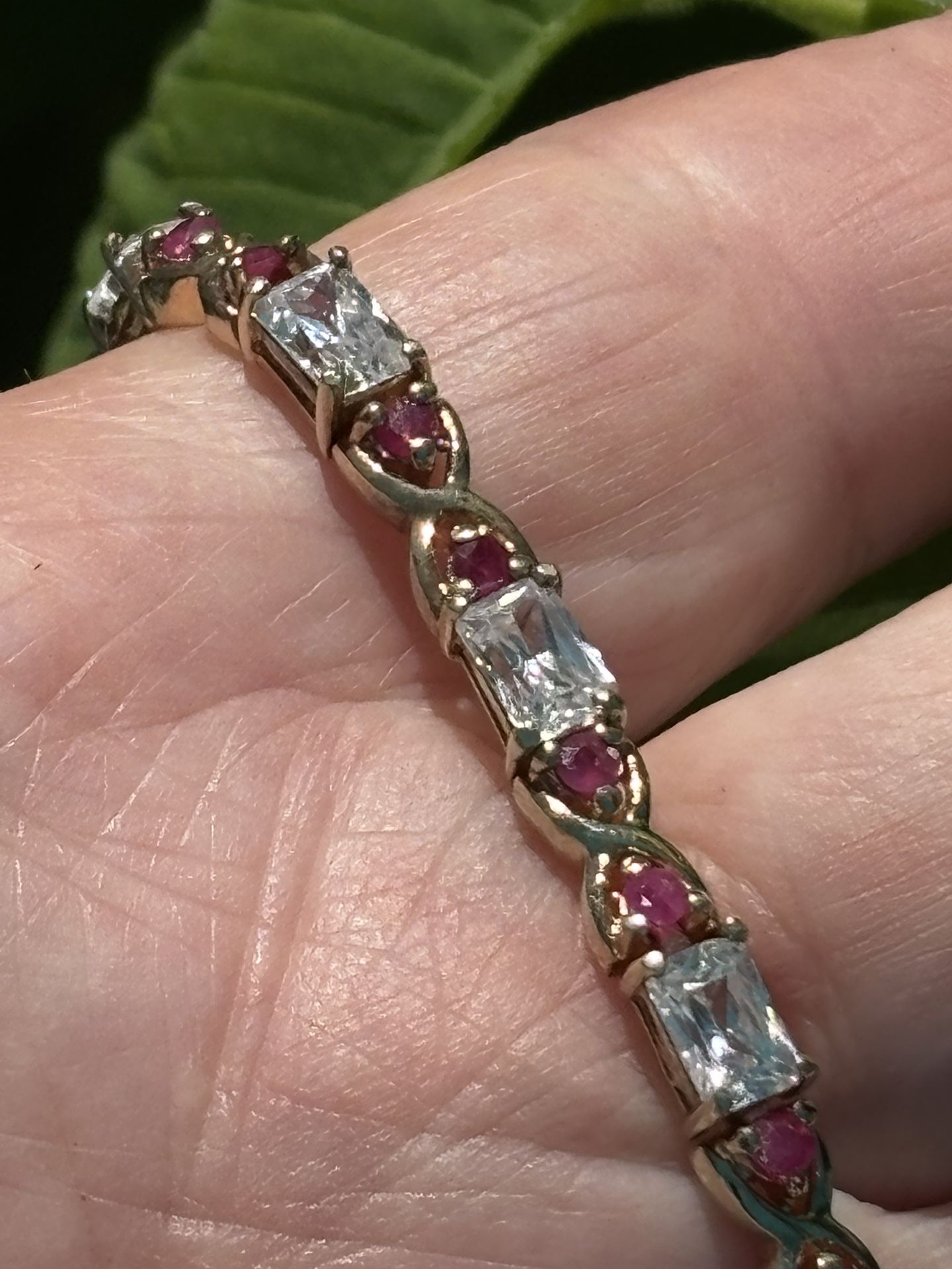 18KT gold plated 7.25” bracelet with round Ruby and Radiant cut clear CZs Marked 925