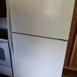 White GE Flattop Range and Whirlpool Refrigerator Freezerl