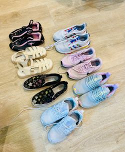 Assortment of girls shoes including Nike, Vans and Adidas.