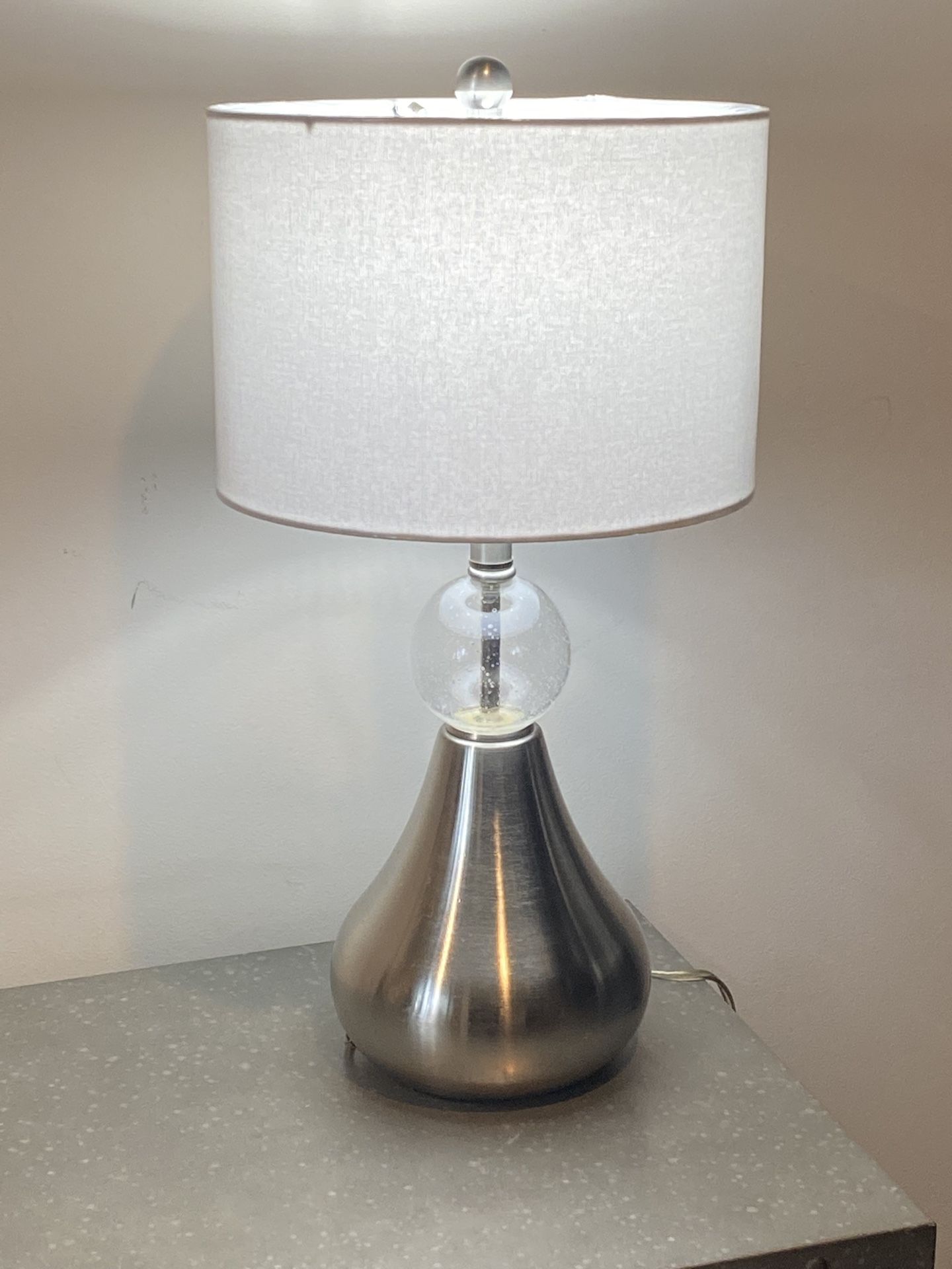 Contemporary Table Lamp With The Brushed Nickel Base And Round Glass Insert H25”