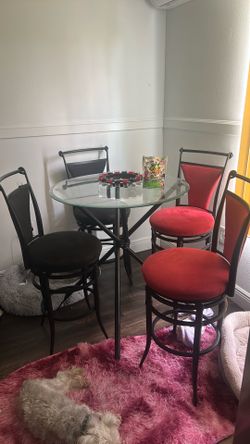 Glass top table with 4 bar stool chairs 2 velvet red and 2 velvet black