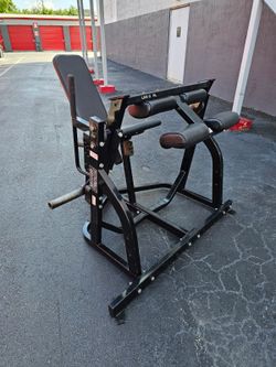 $500 Hammer Strength Plate-Loaded Seated Leg Curl.
Delivery for extra.

Professional-grade gym equipment is a black Hammer Strength plate-loaded seate