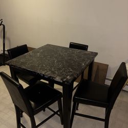 small square faux-marble dining table with 4 bar-height chairs