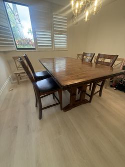 Brown dining room table with six chairs