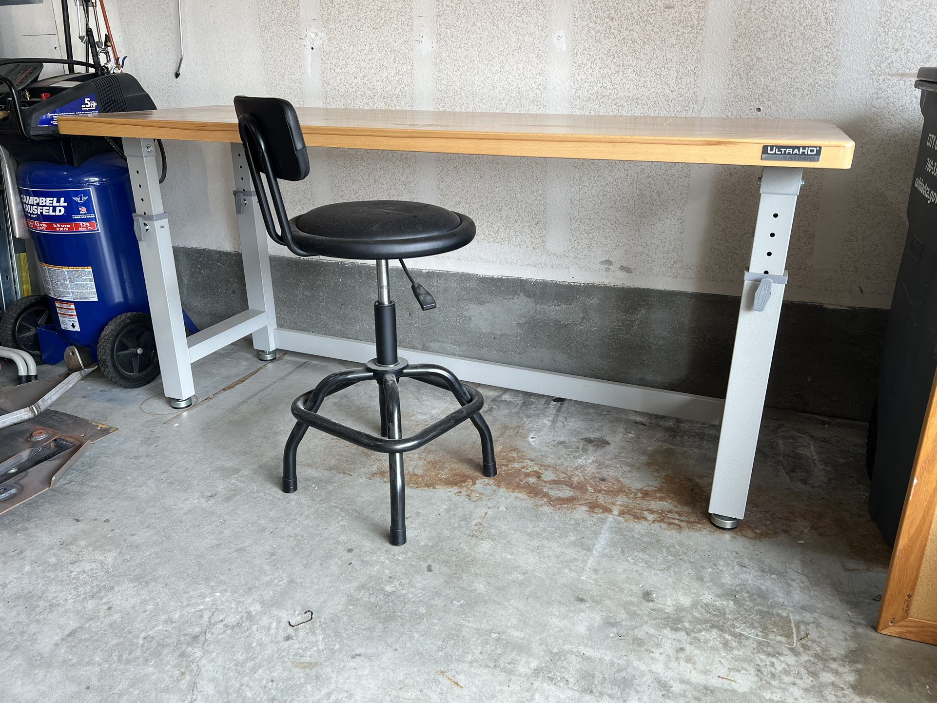 Adjustable height workbench with chair.