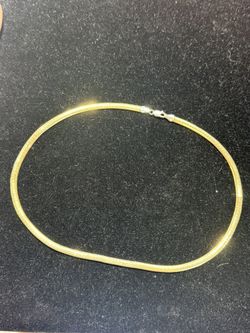 This is a 14K two-tone reversible omega chain necklace