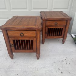 Two matching solid wood nightstands with pedestal feet