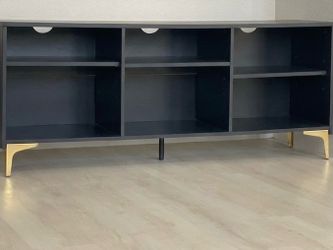 Black TV stand with gold legs