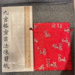 Chinese calligraphy paper and red pouch